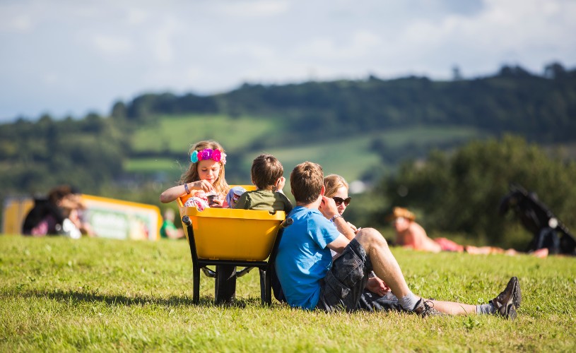Kids sat in wheelbarrow by parents at Valley Fest